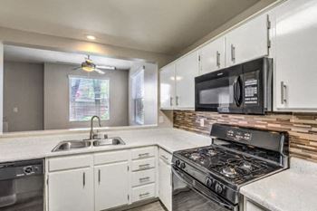 Madison at Black Mountain apartments in Henderson, NV 89015 photo of a kitchen with a stove top oven next to a sink
